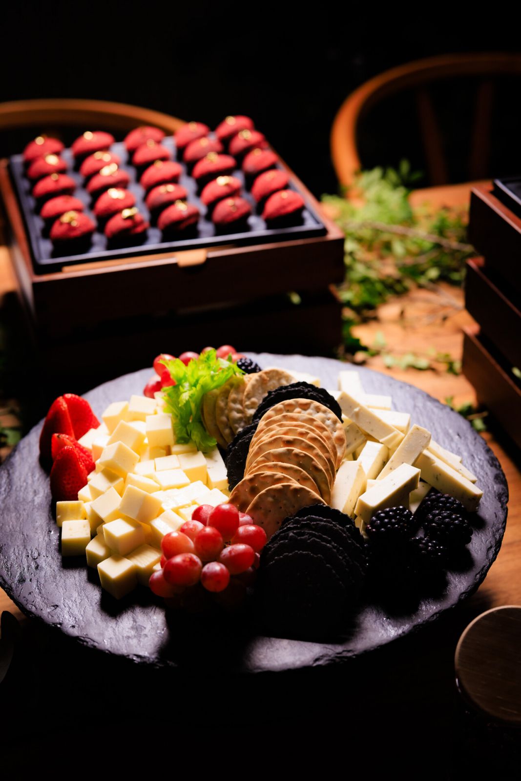 Plant-based Green Rebel cheddar and truffle cheeses paired with a selection of crackers and fresh berries