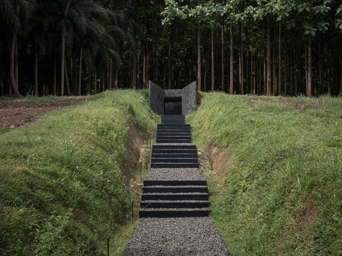 A narrow, stone-lined pathway leading up to the amphitheatre