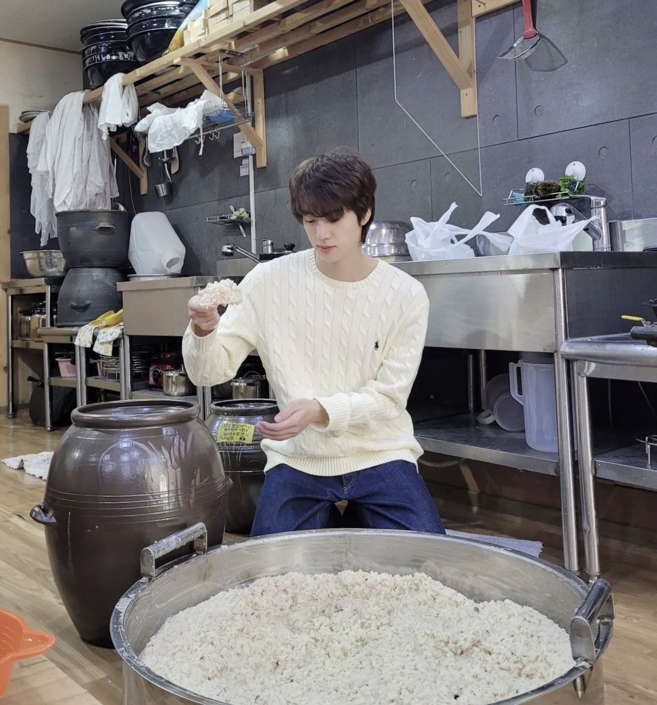 Jin making makgeolli, a traditional Korean rice liquor (image courtesy of Instagram / @jin)