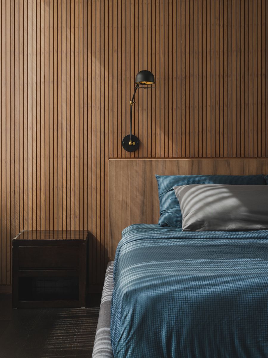 Timber slats form the backdrop to the master bedroom's sleeping area