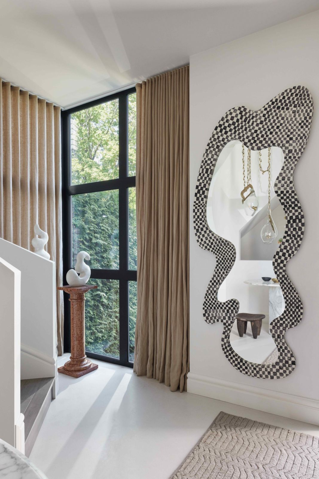 The playful shape of a bespoke chequered mirror by Hannah Polskin