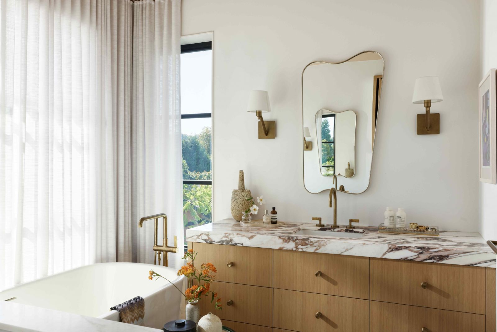 The warm-toned primary bathroom