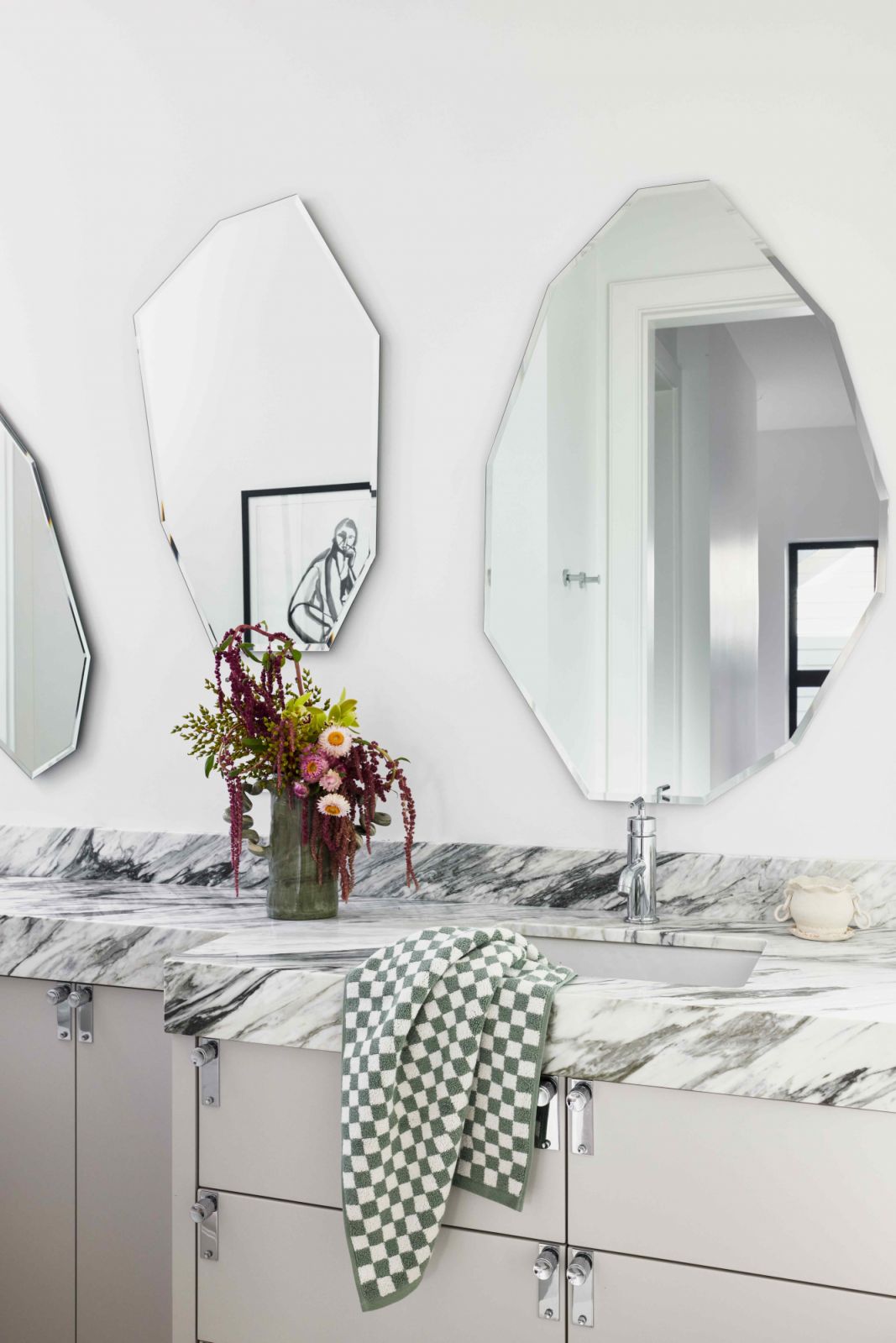 Sprightly shaped mirrors decorate the kids' shared bathroom
