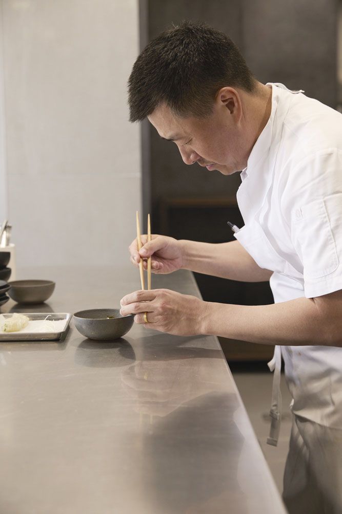 Corey Lee preparing the finishing touches to the dish