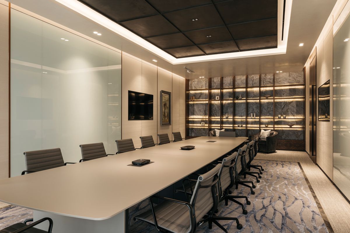 Backlit shelves against a dark backsplash creates an elegant atmosphere in one of the office's meeting rooms (Photo: Anthracyte Studio)