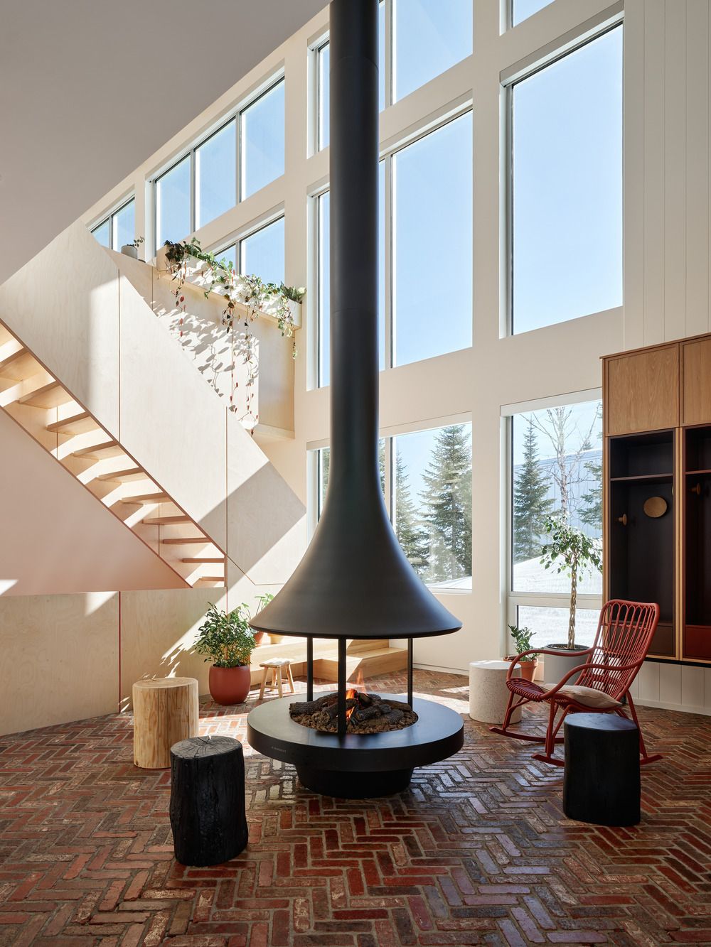 The double-height mudroom with a 1970-style metal fireplace