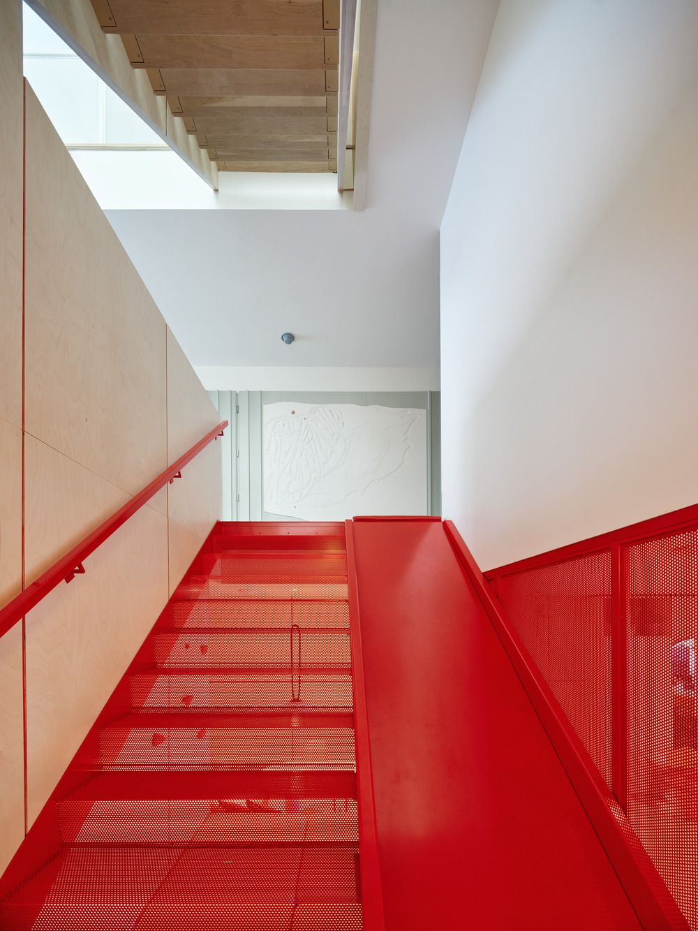 The custom-made red slide that doubles as a steel staircase