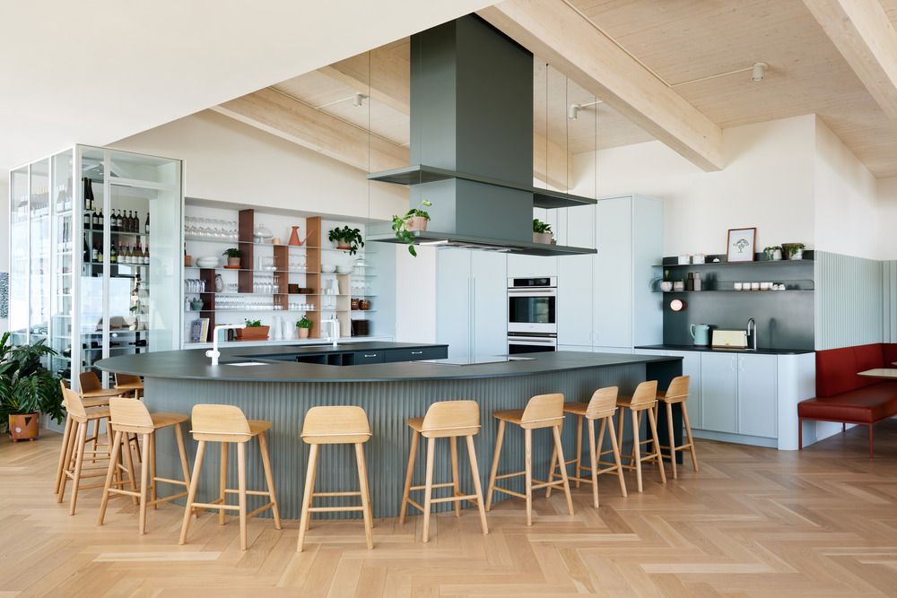 The U-shaped counter that embraces the open chef’s kitchen