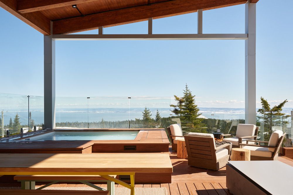 The terrace with a spa and fireplace overlooking the snow-capped panorama