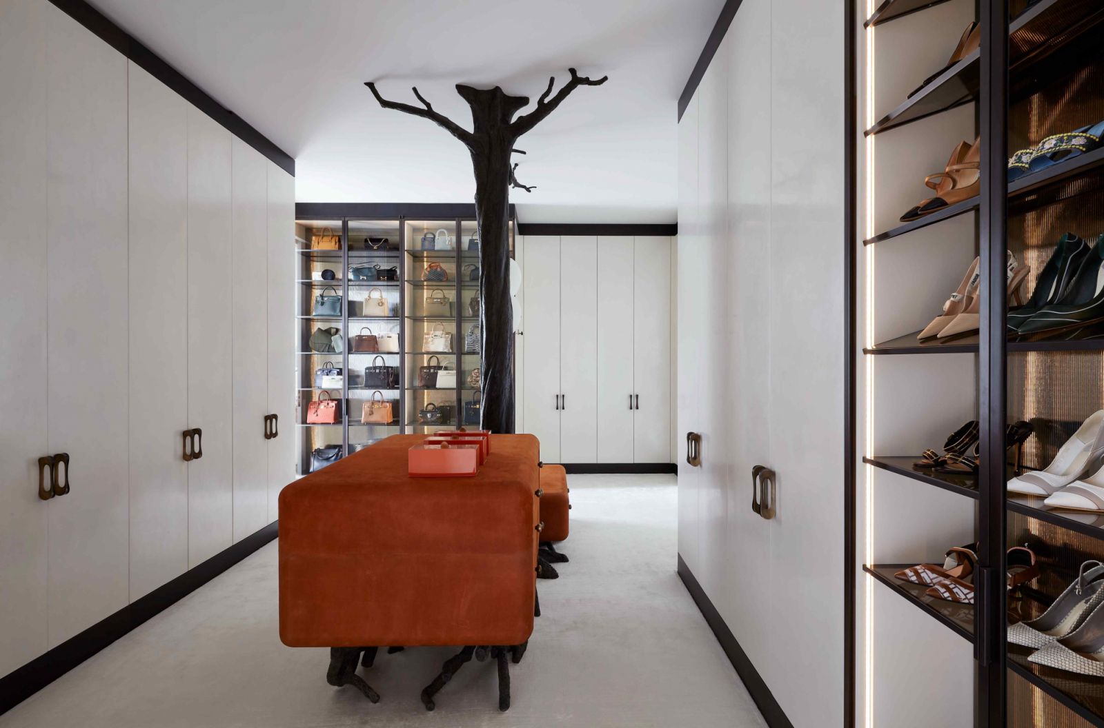 The enlarged primary closet with a custom bronze finish tree sculpture