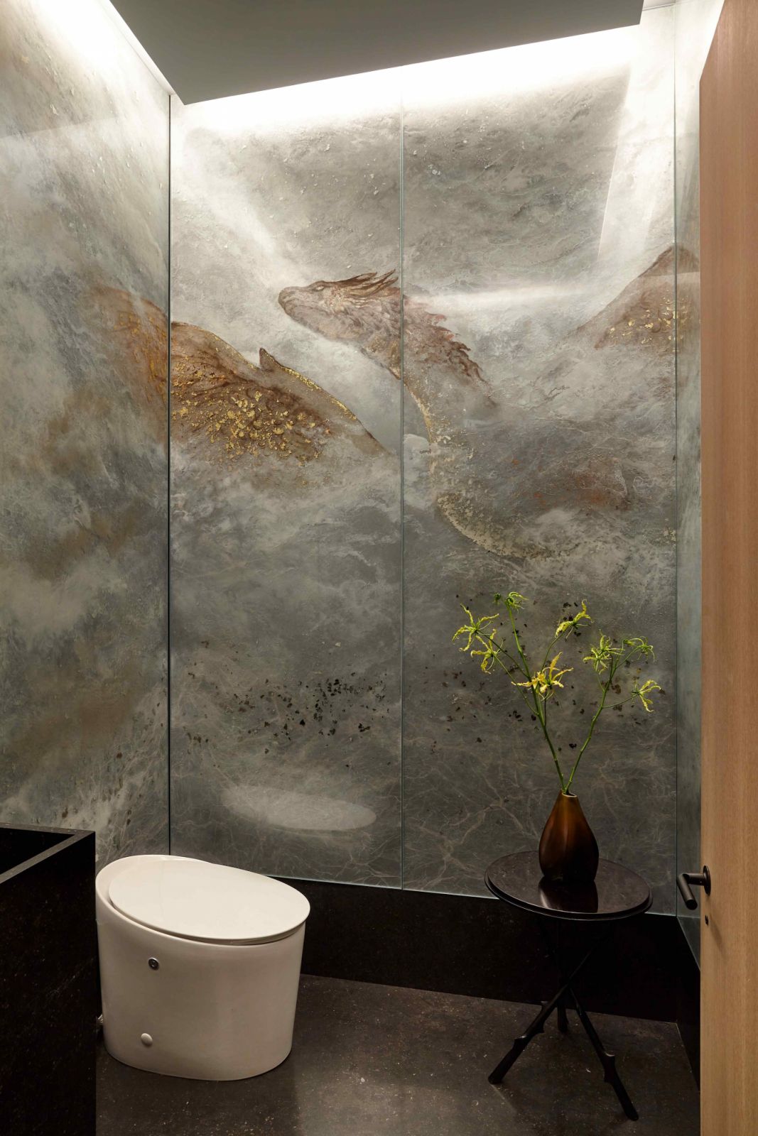 Églomisé wall panels with a dragon motif in the powder room