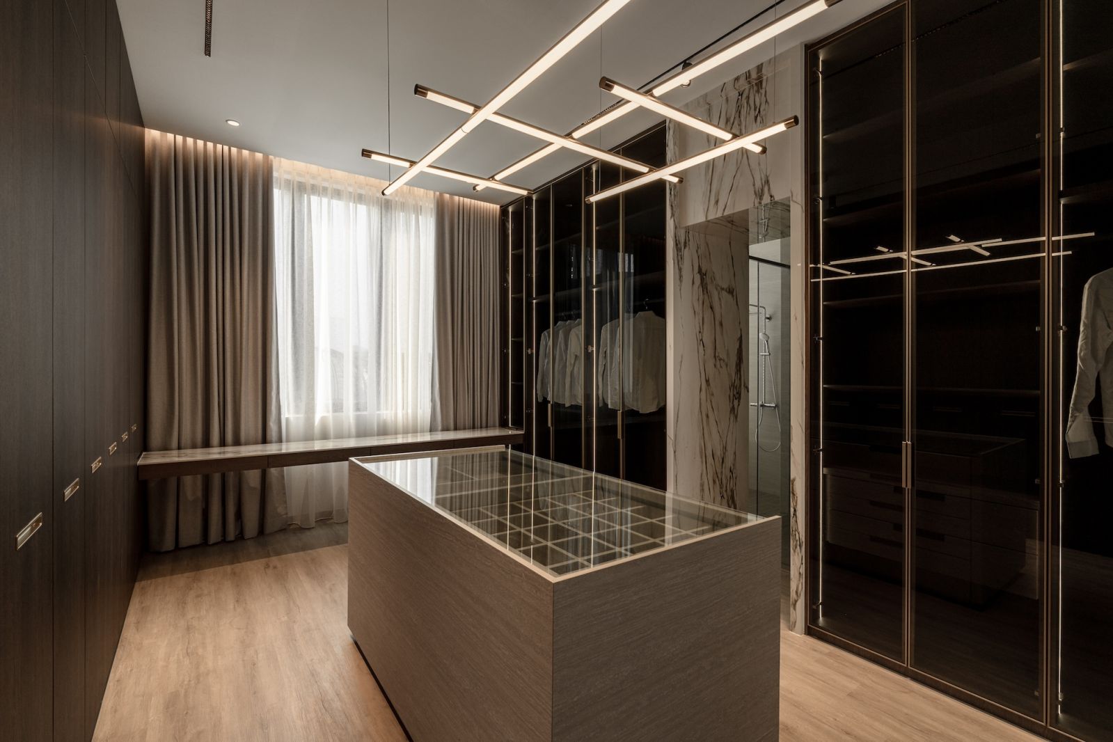 The walk-in wardrobe is enviably spacious and elegantly fitted out