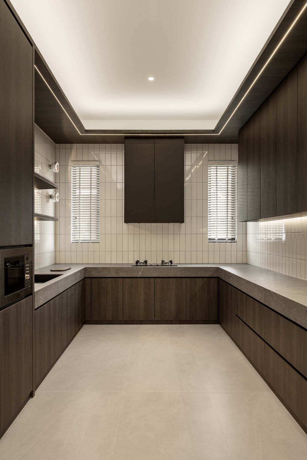The wet kitchen is neatly realised in a darker palette