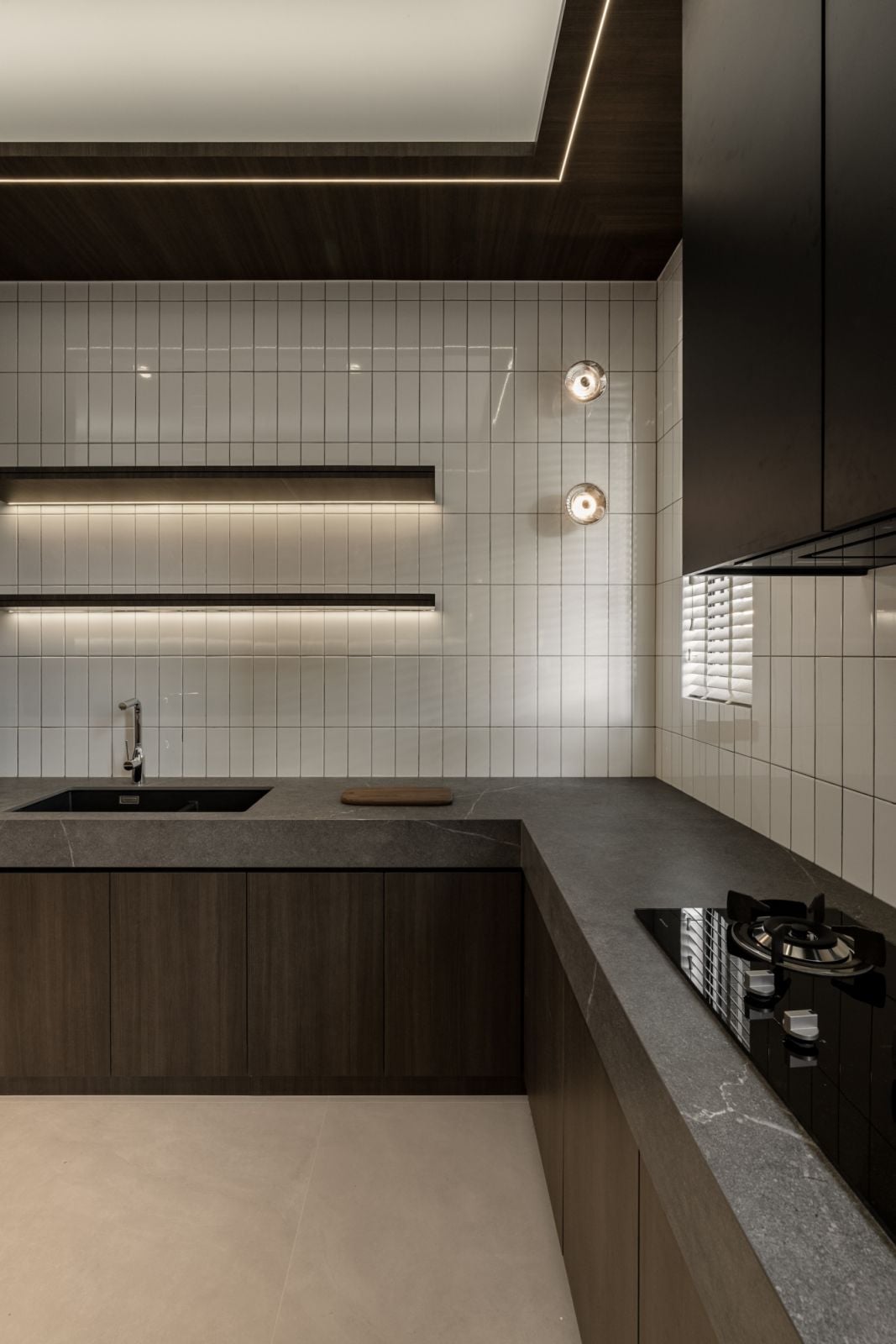 The wet kitchen is neatly realised in a darker palette