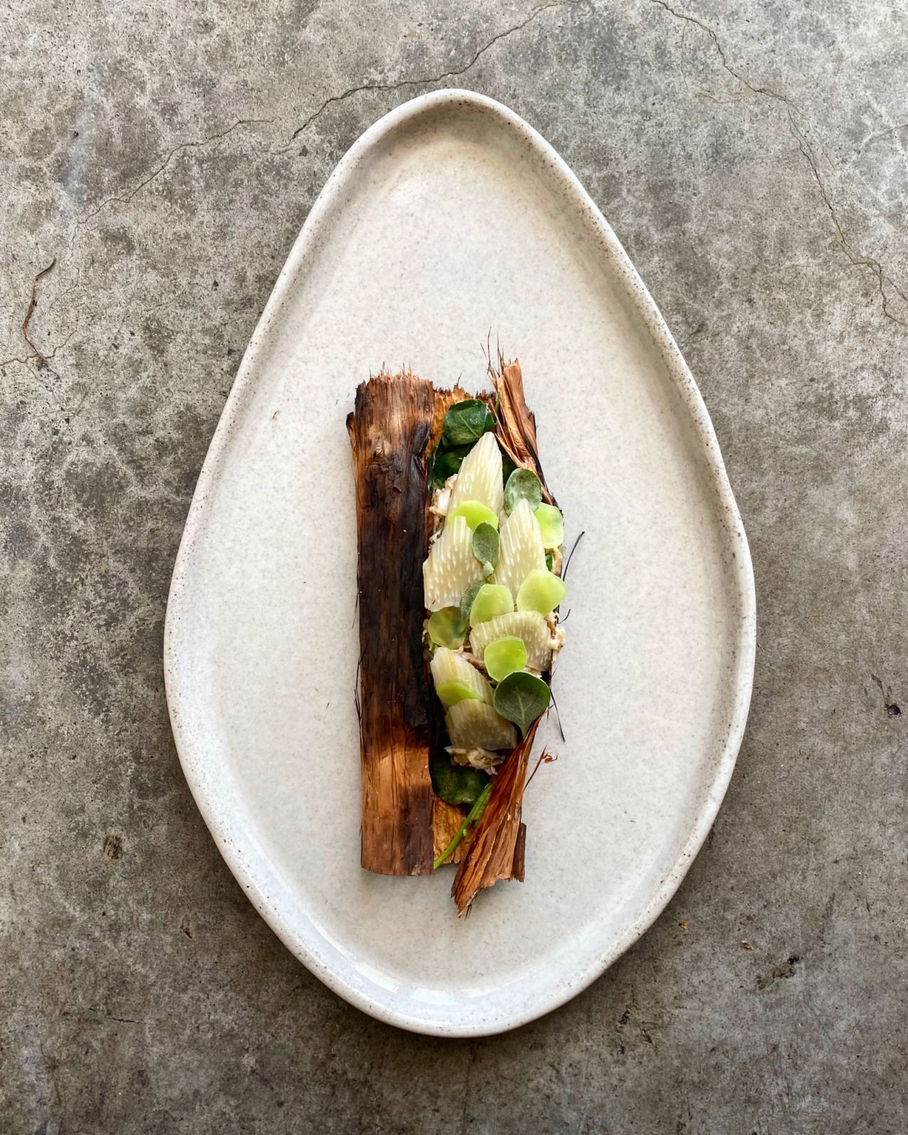 Baby grouper seasoned with preserved kelp, coal-roasted and wrapped in paper bark and salt bush (Photo: Ben Devlin)