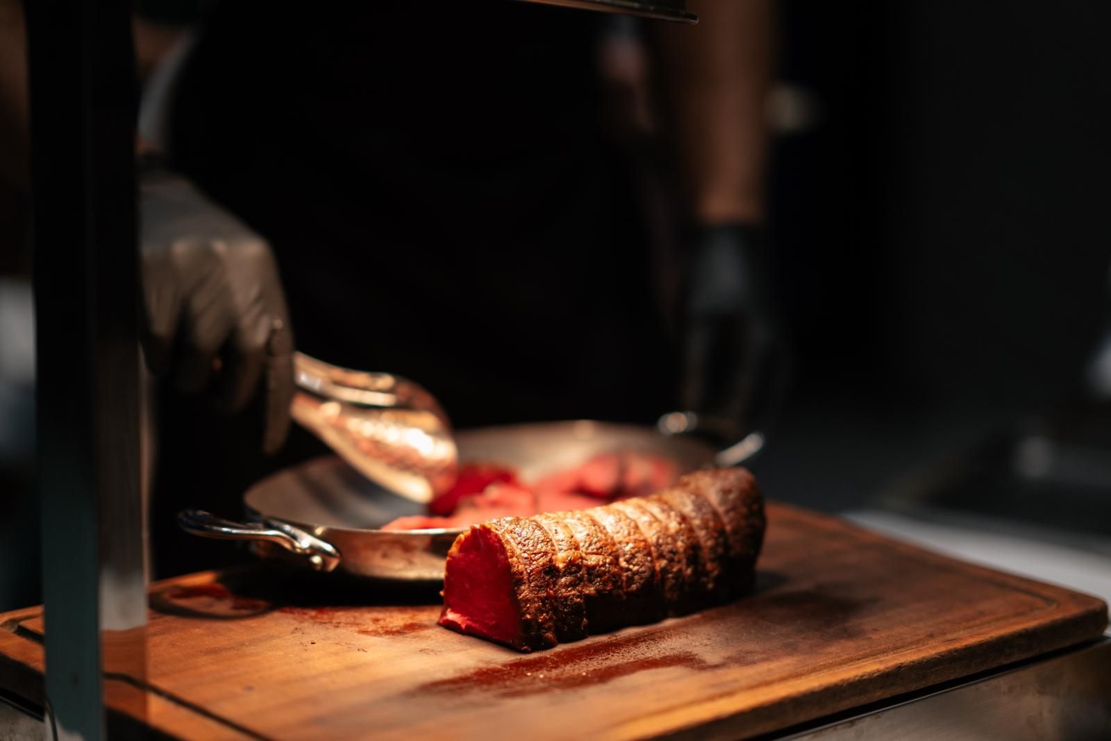 A waiter from Hong Kong hospitality group Black Sheep Restaurants served sliced meat at the Gen.T Leaders of Tomorrow 2024 launch event (Photo: Billy Chan)
