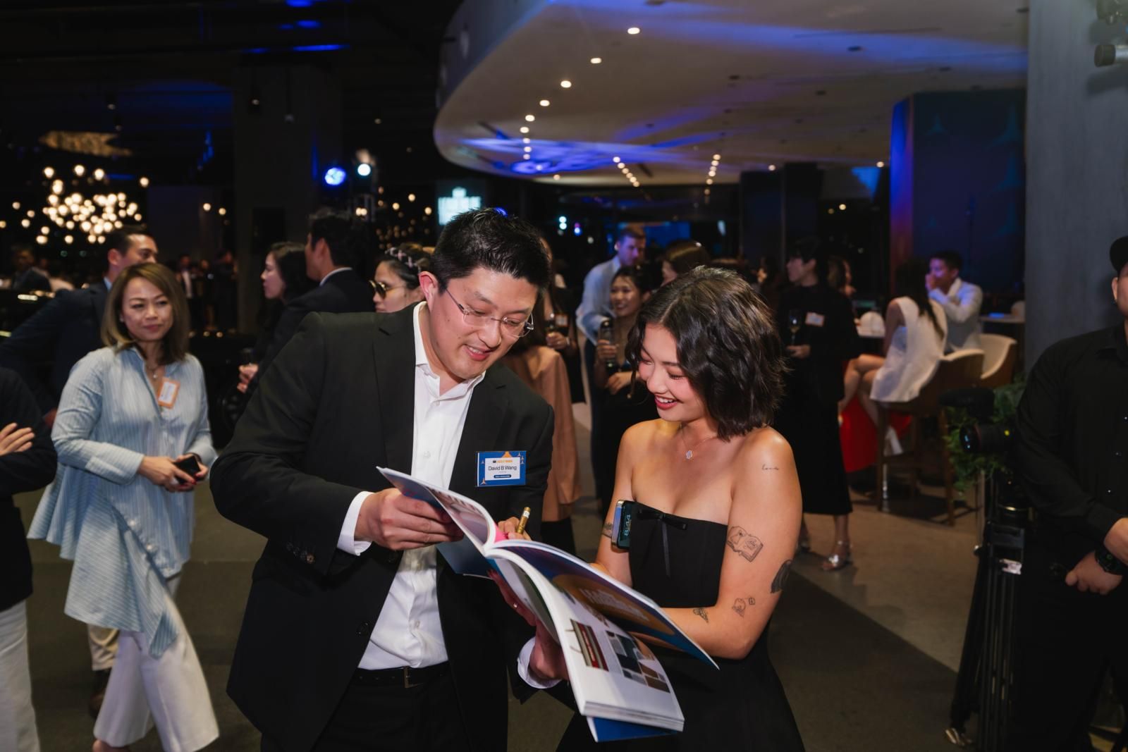 Gen.T Leader of Tomorrow Stephanie Hui signed on fellow honouree David B Wang's personalised magazine (Photo: Humphrey Ng)