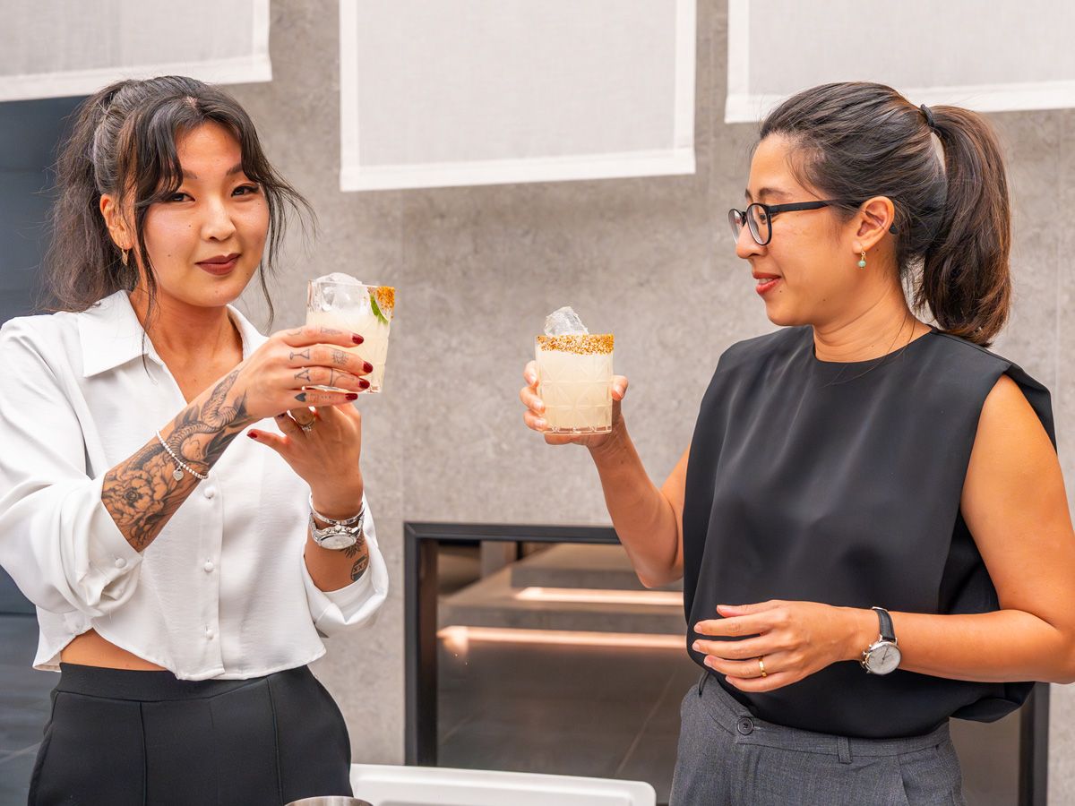 Maria Kim and Chayanit Boonma toast one another after their margarita mixing session