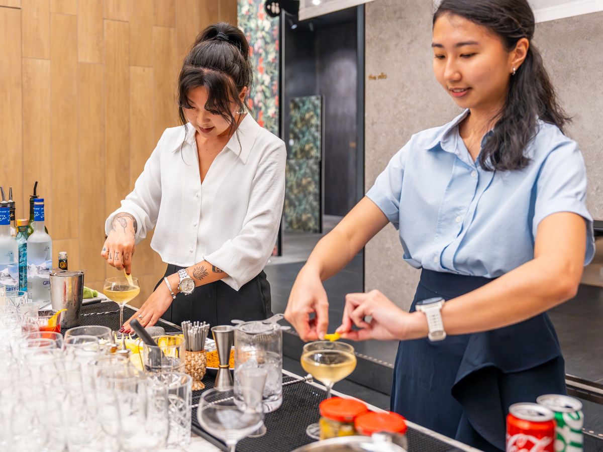 Maria Kim and Naomi Bachtiar giving their martini a lemon twist