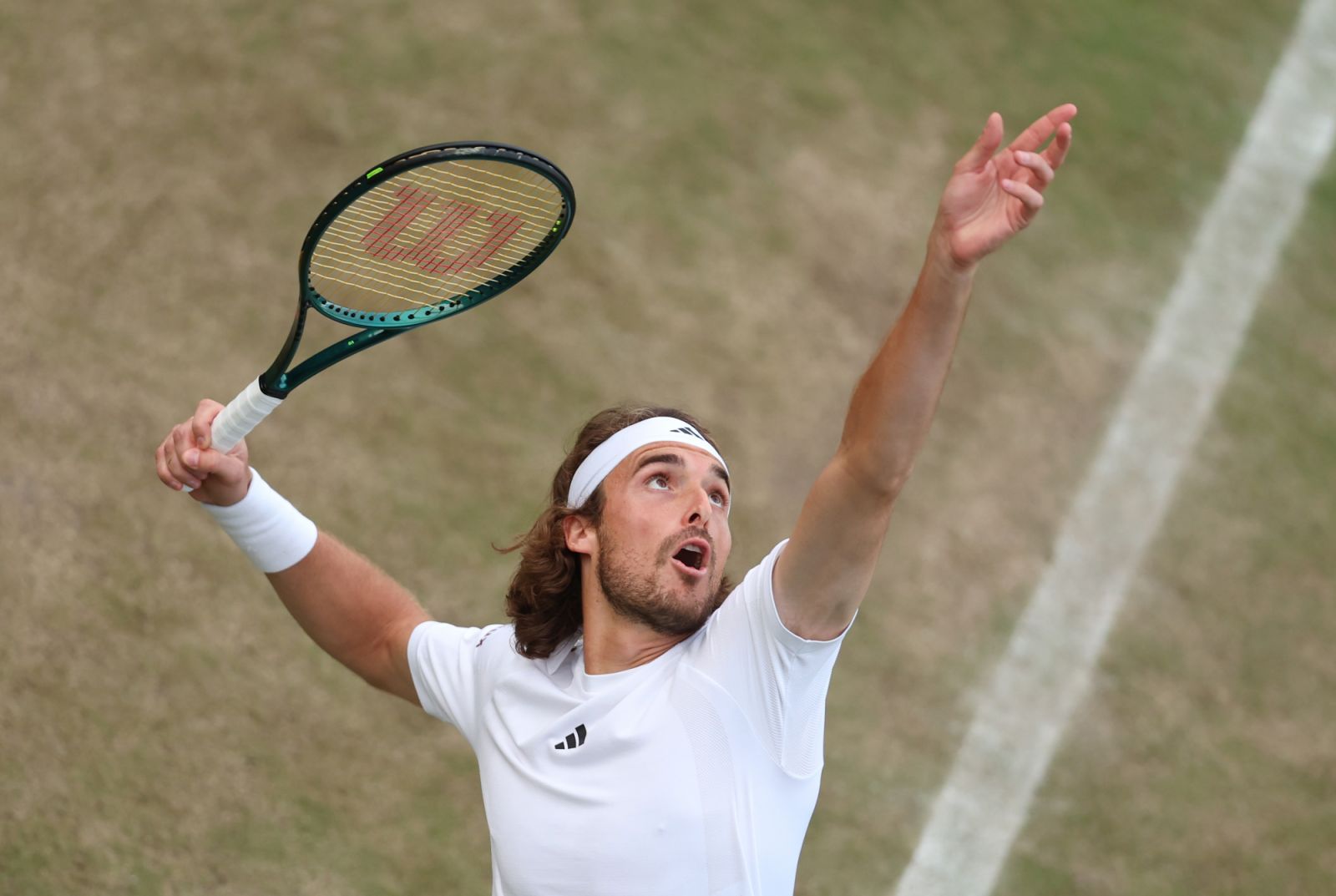 Stefanos Tsitsipas of Greece serves as he plays with Petros Tsitsipas of Greece in his Gentlemen's Doubles first round match against Maximo Gonzalez of Argentina and Andres Molteni of Argentina during day three of The Championships Wimbledon 2024 (Photo by Julian Finney/Getty Images)