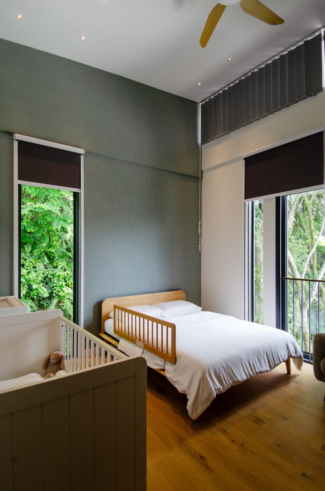 Large windows open up to the surrounding greenery