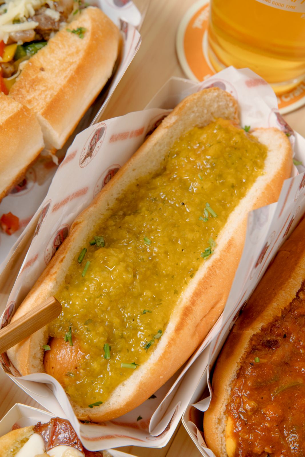 A hot dog coated in jalapeño and peach jam