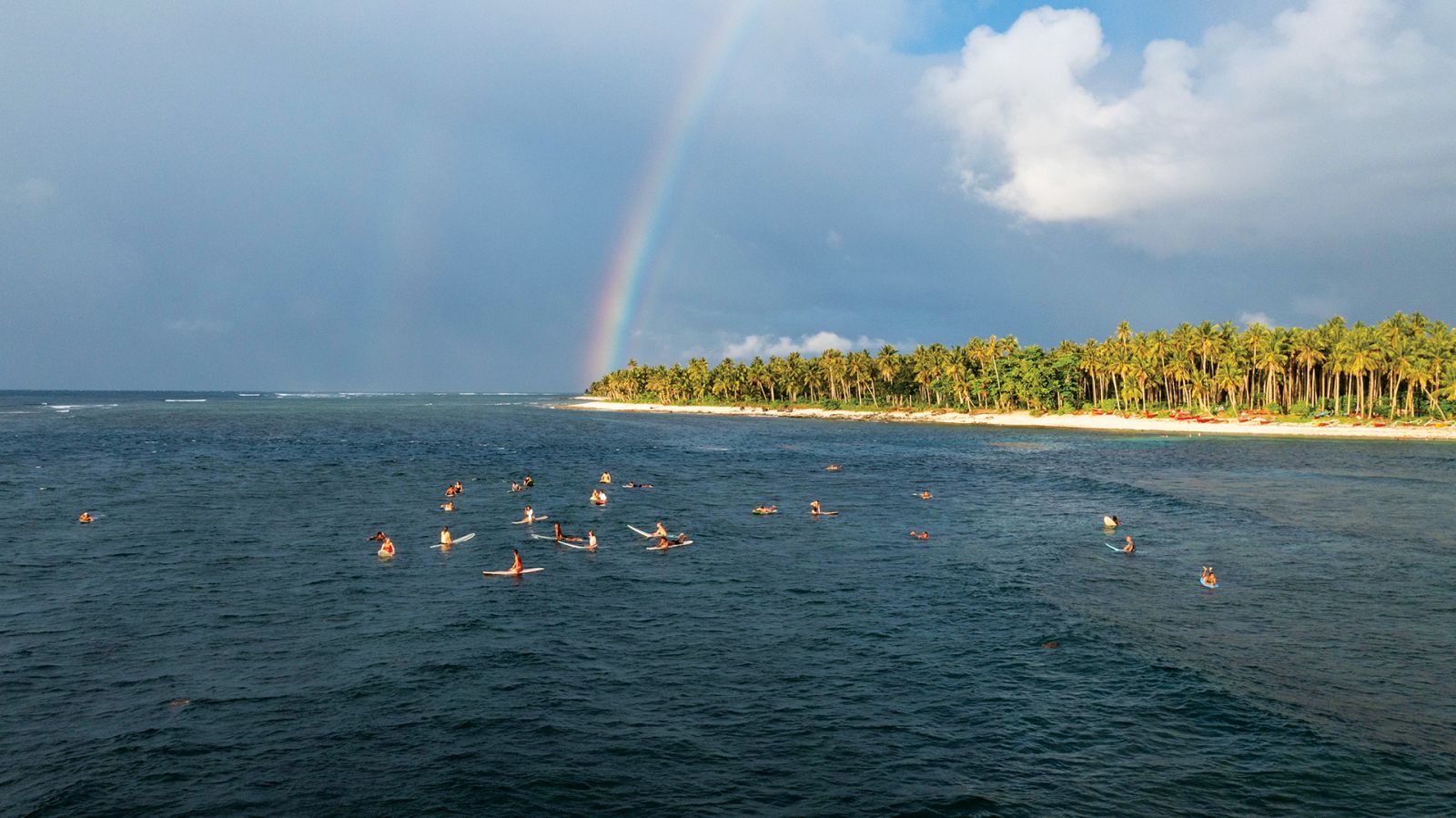 Surfers patiently wait for the waves of Siargao