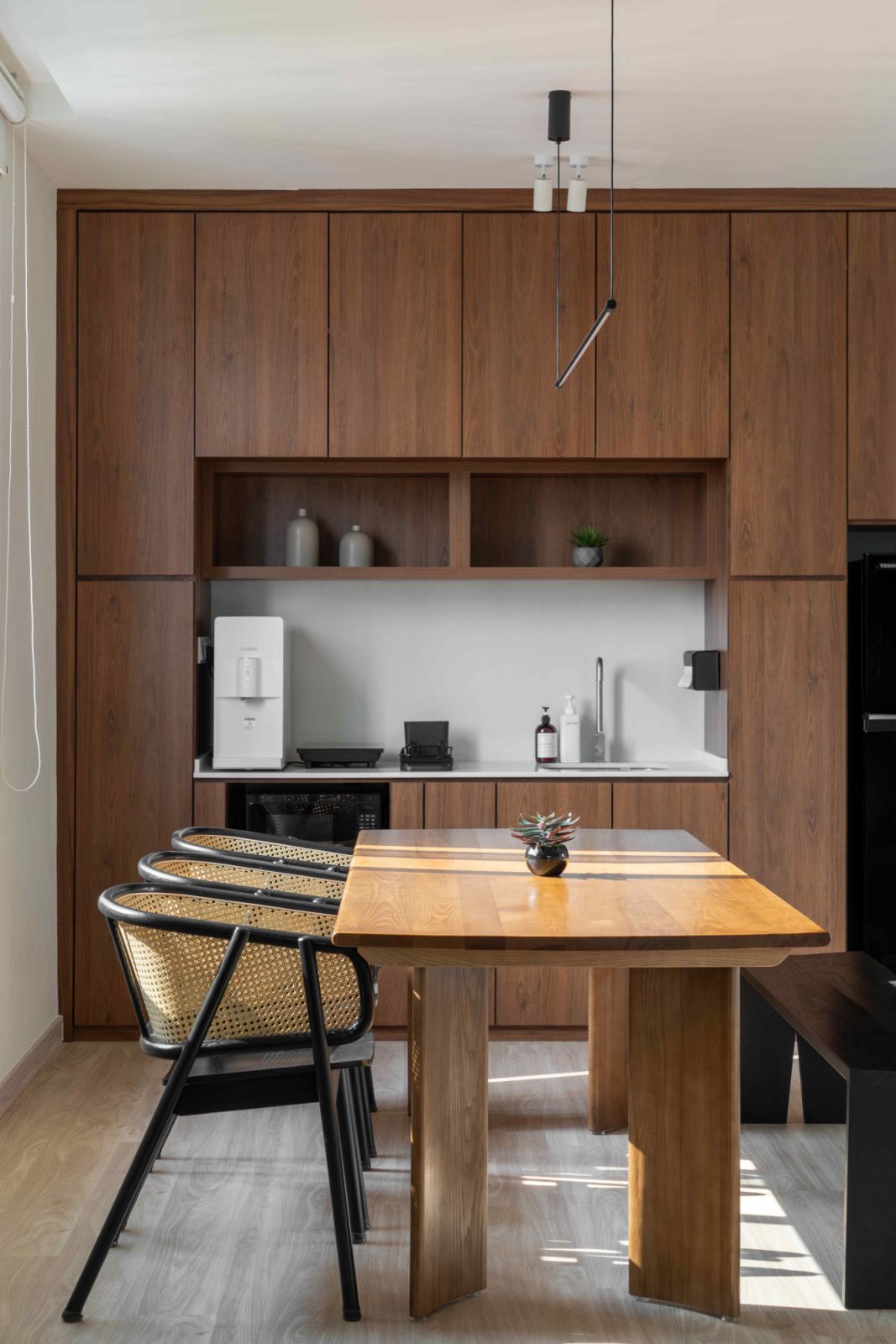 Warm wood in the spacious kitchenette and dining areas (Photo: Courtesy of CEED Design)