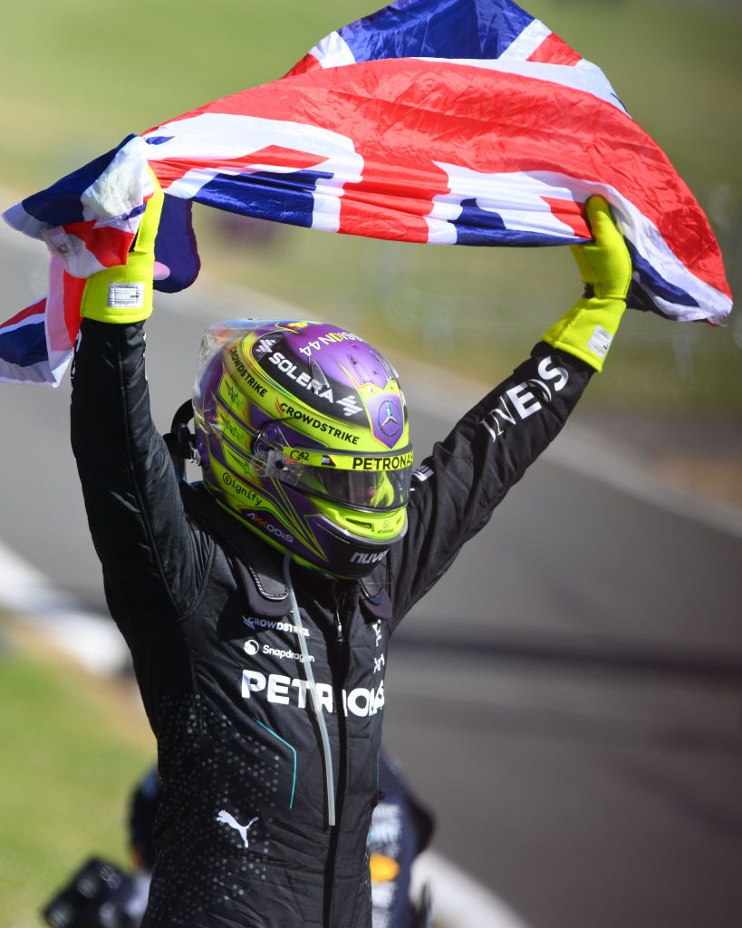 Lewis Hamilton of Great Britain and Mercedes-AMG Petronas F1 is celebrating by holding the Union flag during the Formula 1 Qatar Airways British Grand Prix at the Silverstone Circuit in Towcester, England, on July 5, 2024. (Photo by MI News/NurPhoto via Getty Images)