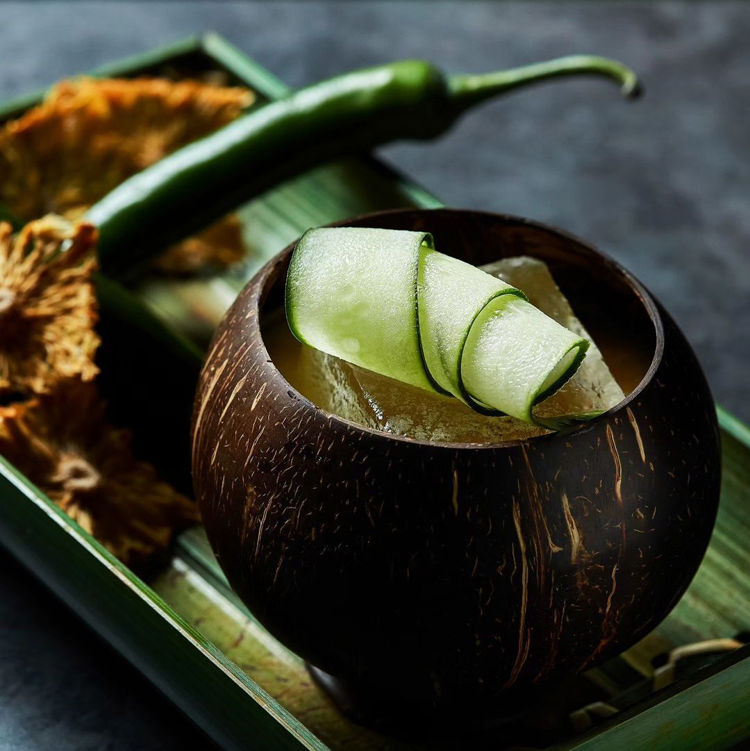 A cocktail from Junglebird featuring Diplomatico Planas, rojak, cucumber, green chilli shrub, and pineapple (Photo: Instagram / @junglebirdkl)