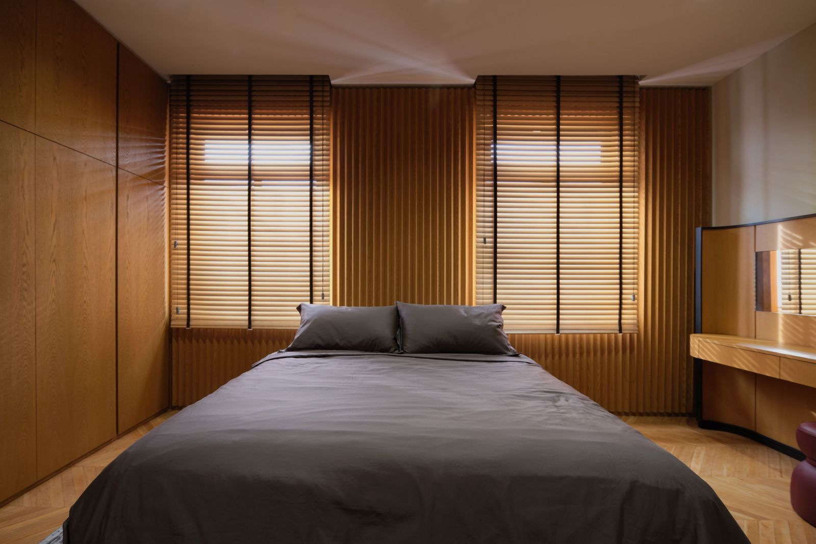 Natural light filters into the slatted blinds;