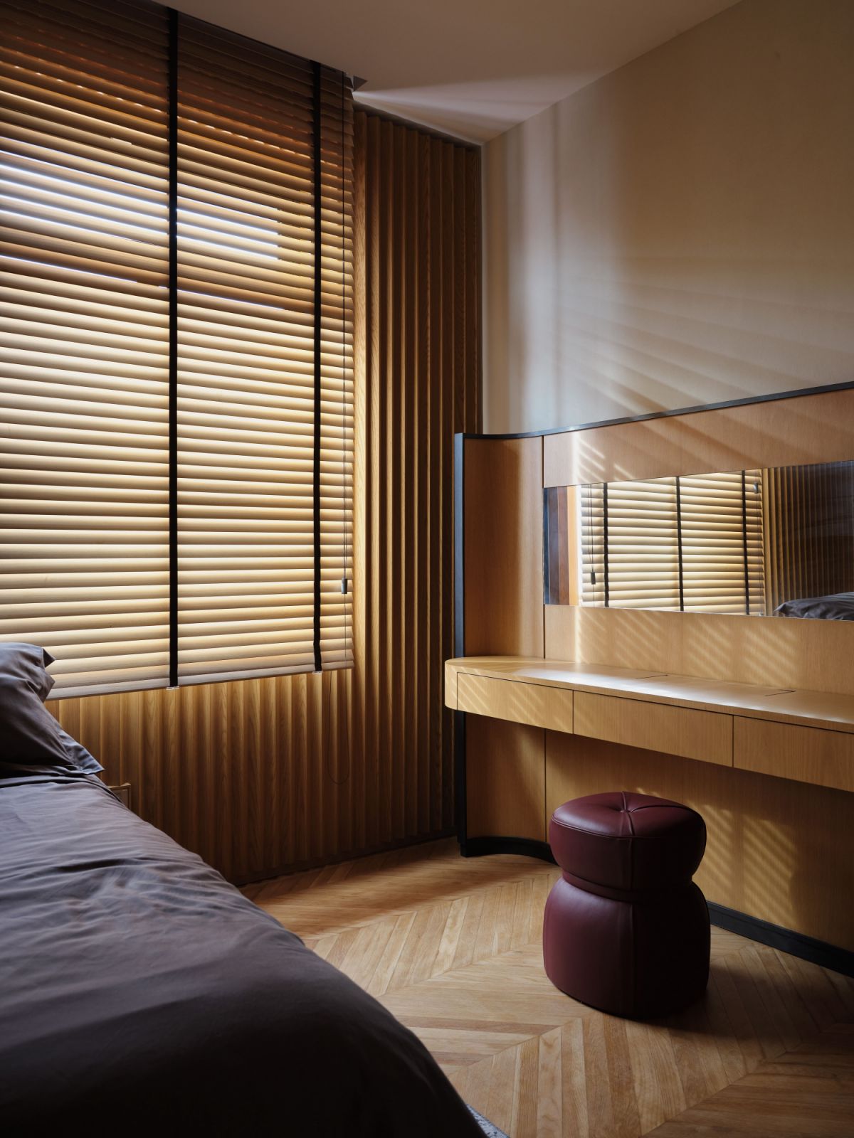 Natural light filters into the slatted blinds
