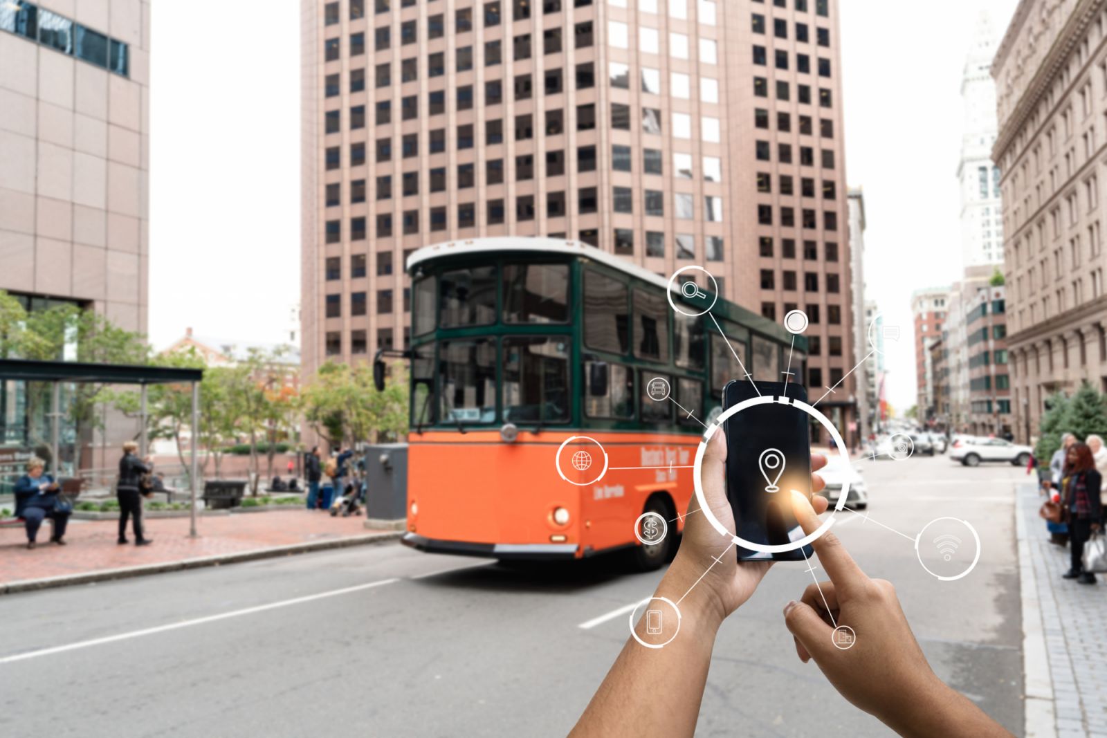 Hand holding tablet use AR application to check relevant information. Boston in street background concept