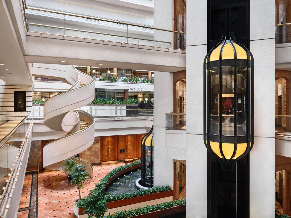 The interplay between the bubble elevators and spiral staircase gives the space an old-school luxurious touch
