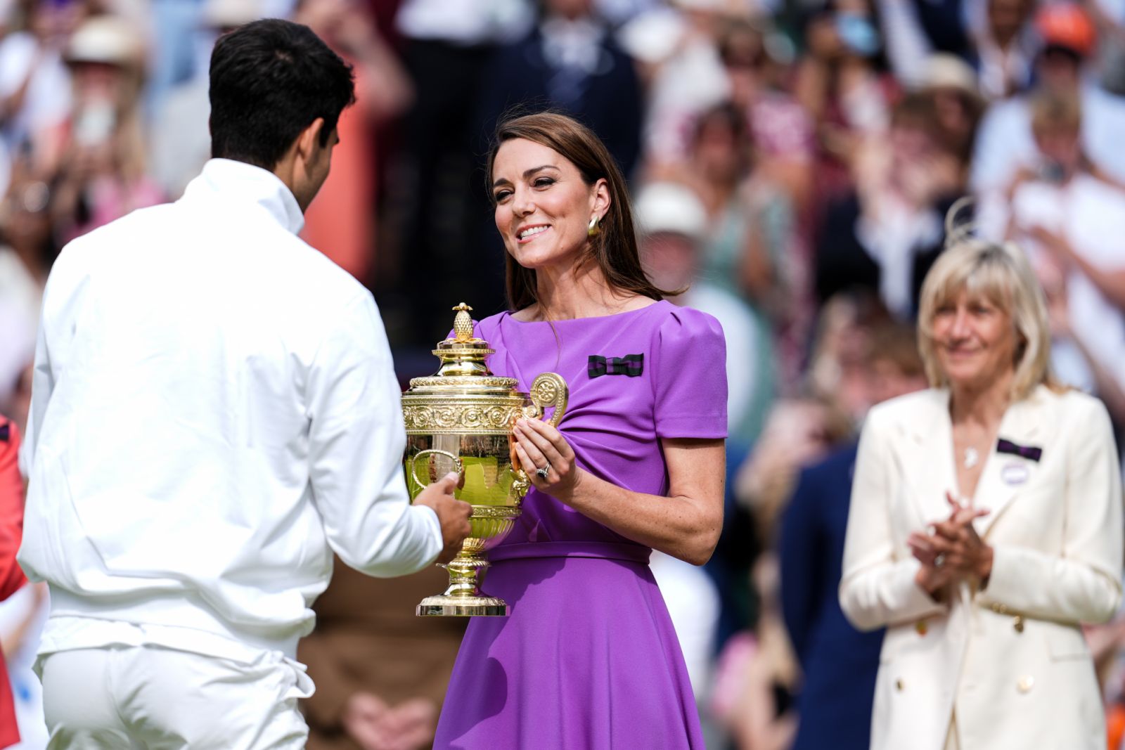 LONDON, ENGLAND - JULY 14: Catherine, Princess of Wales gives the Gentlemen's Singles Trophy to Carlos Alcaraz of Spain during the ceremony after the Men's Single Final Match during day fourteen of The Championships Wimbledon 2024 at All England Lawn Tennis and Croquet Club on July 14, 2024 in London, England. (Photo by Shi Tang/Getty Images)