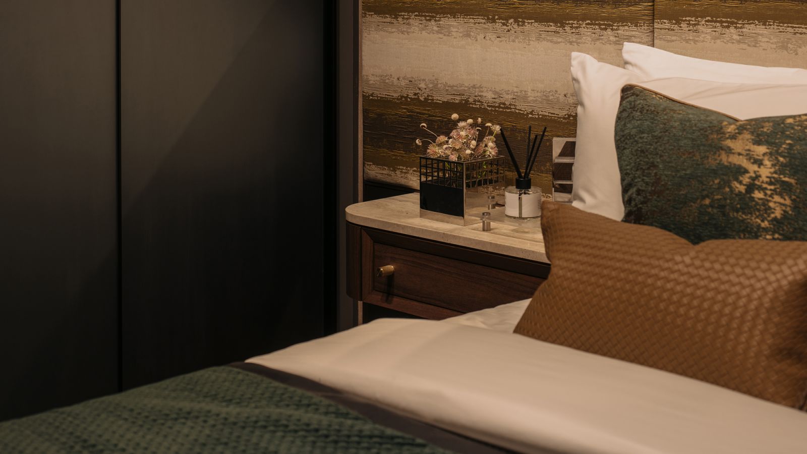 The headboard in the master bedroom features a pattern inspired by travertine