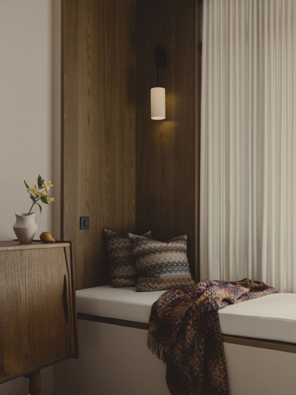 A quiet nook nestled next to the window allows for light to filter in