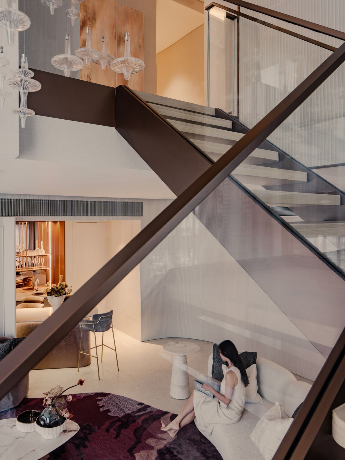 Cosy corners are created through situating key furniture pieces near the staircase