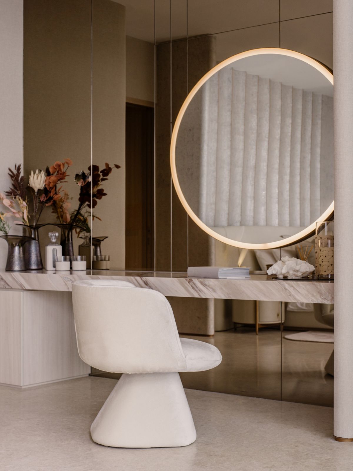 The master suite with a dedicated dresser area with plush textures