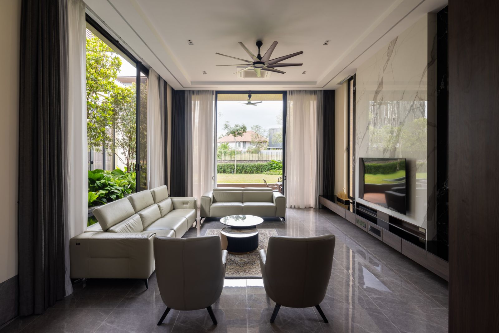 The living room looks out to the green expanse