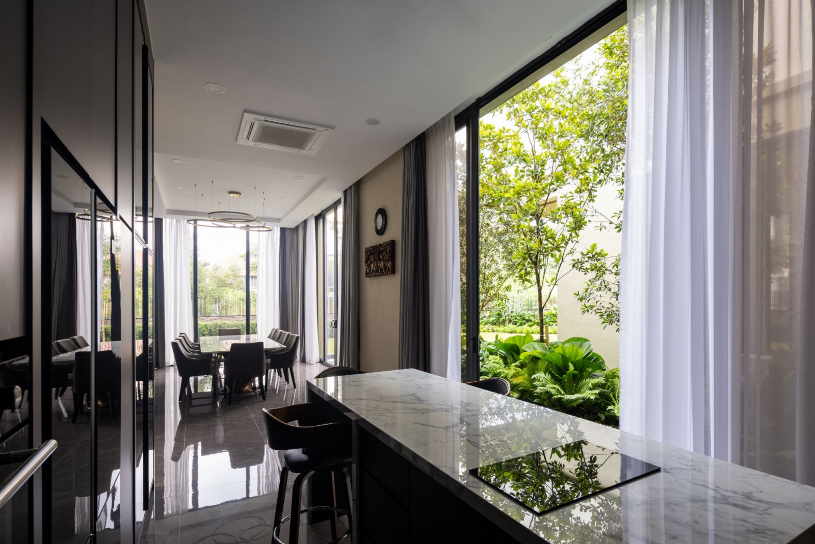 Cooking and dining spaces look out to greenery