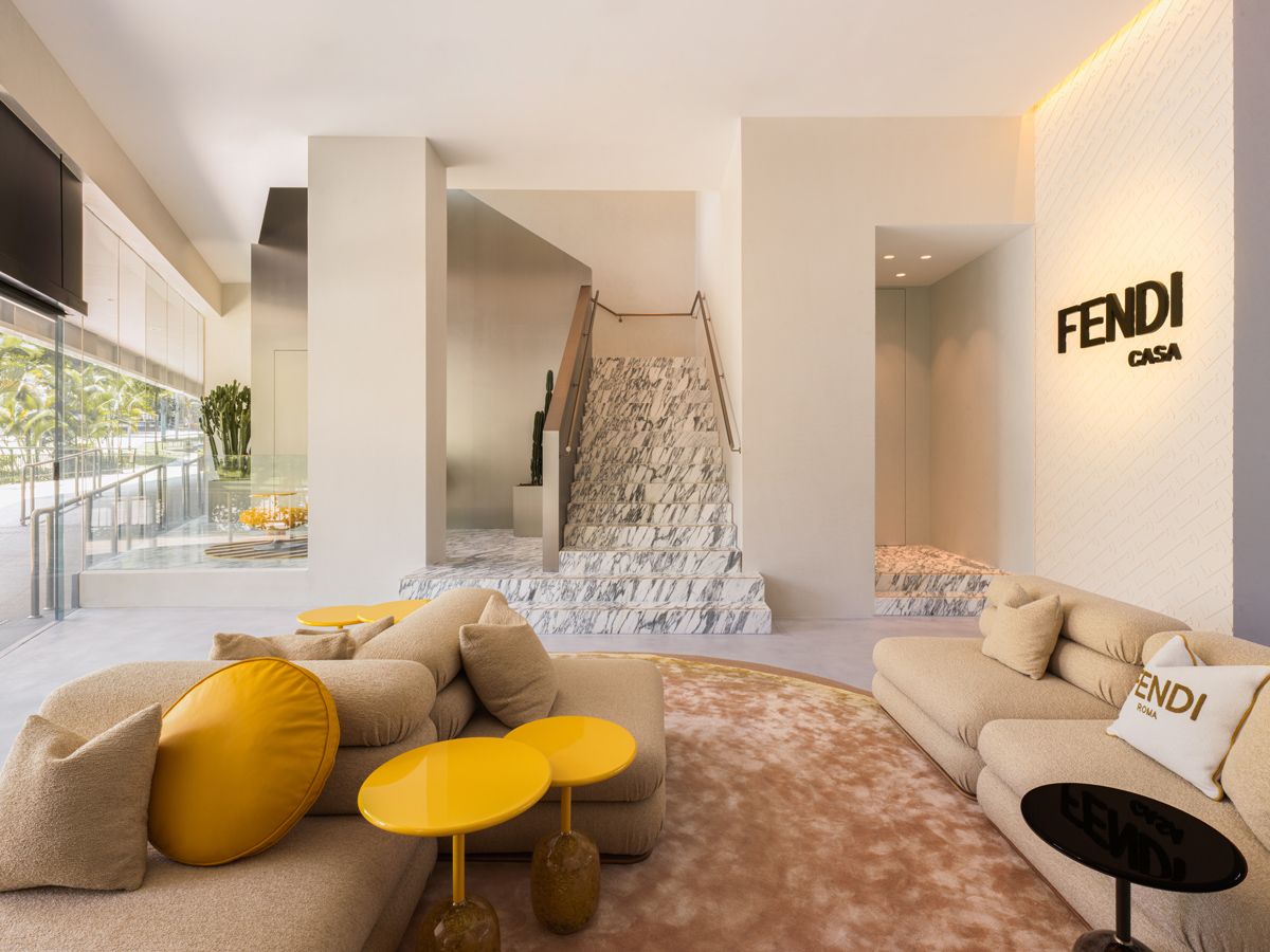 A marble staircase connects the two levels of Fendi Casa Singapore