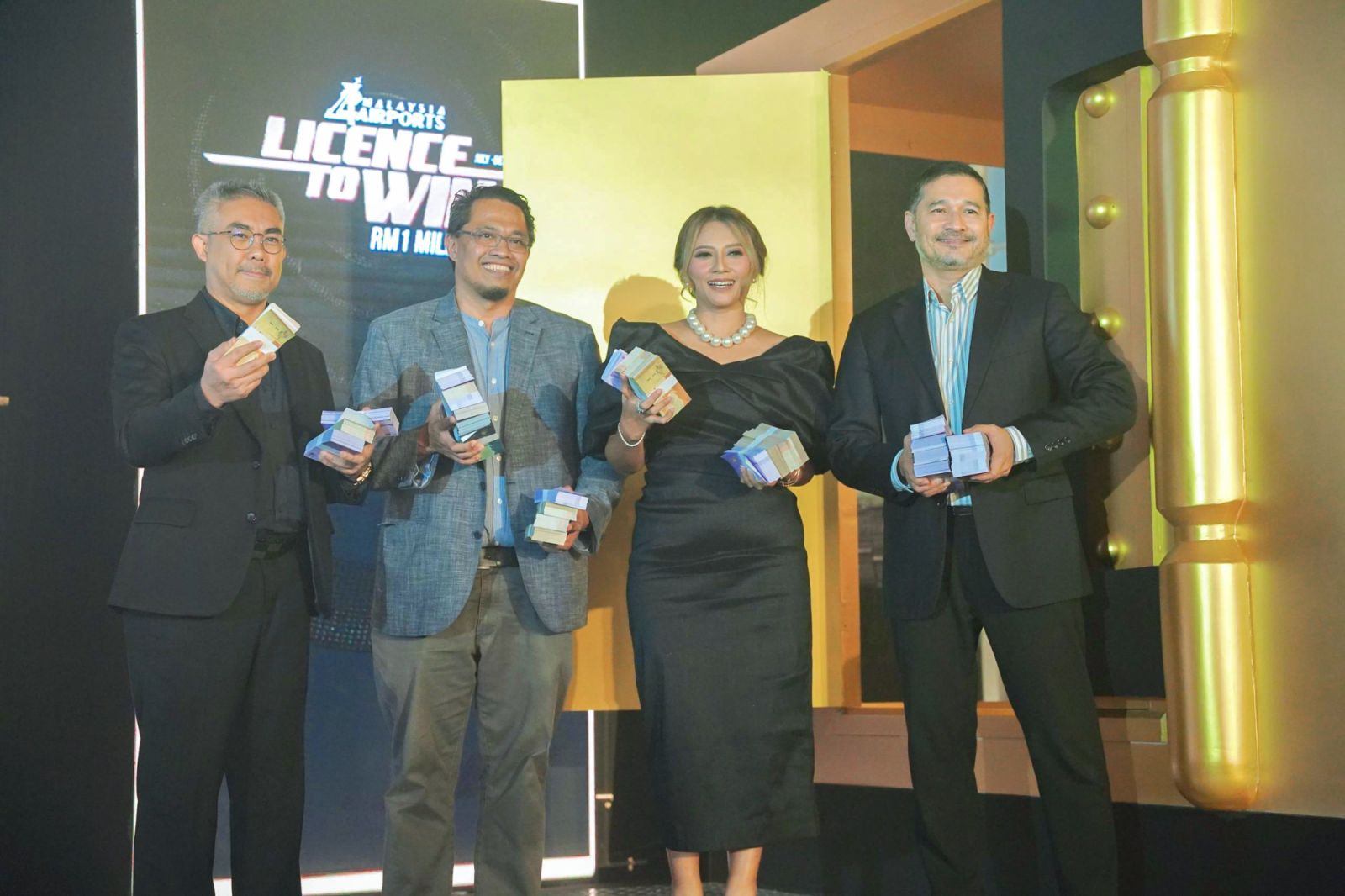 Malaysia Airports leadership posing in front of the gleaming money vault representing the RM1 million grand prize