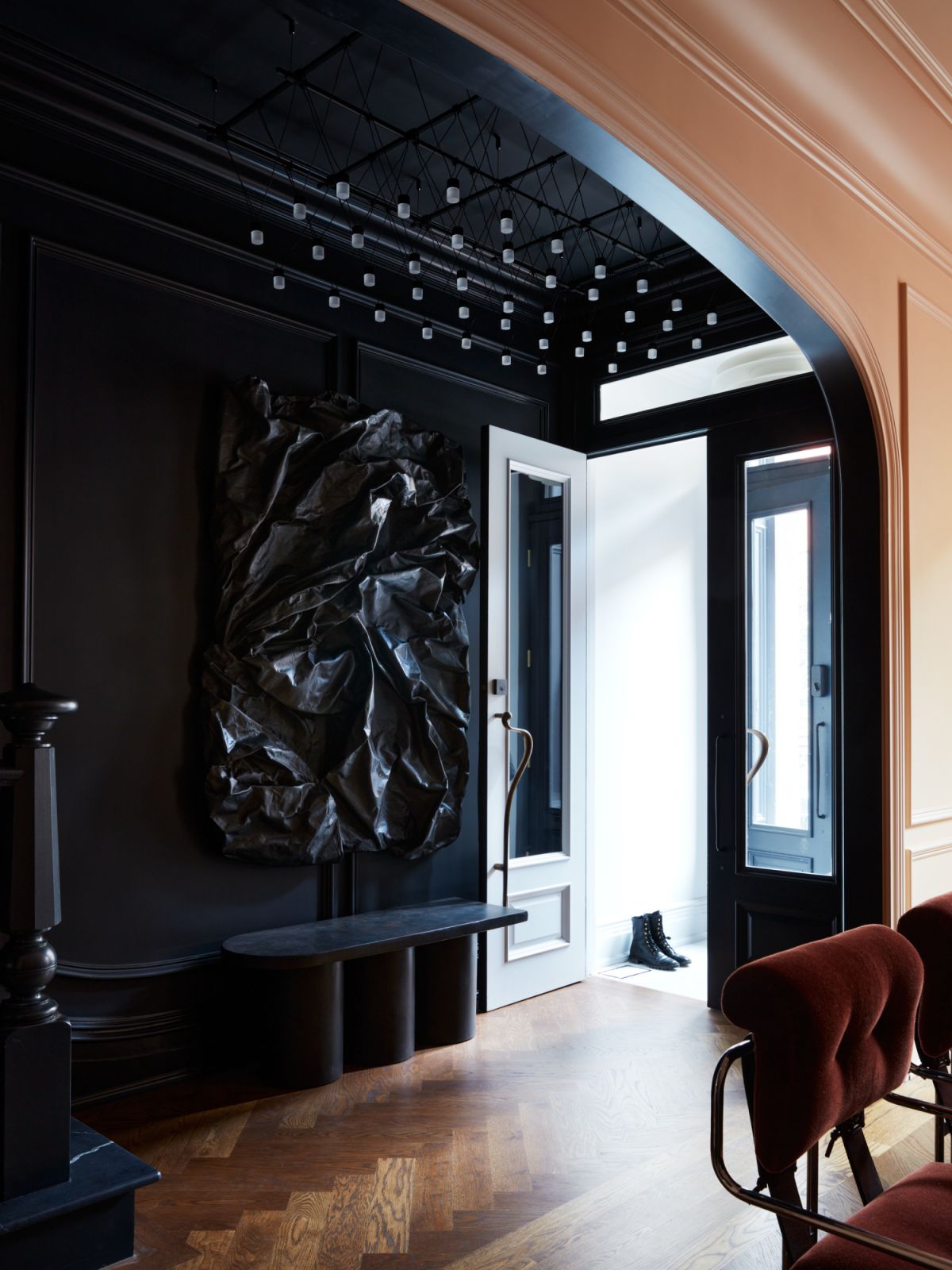 The bright entry vestibule leads into the moody entry hall