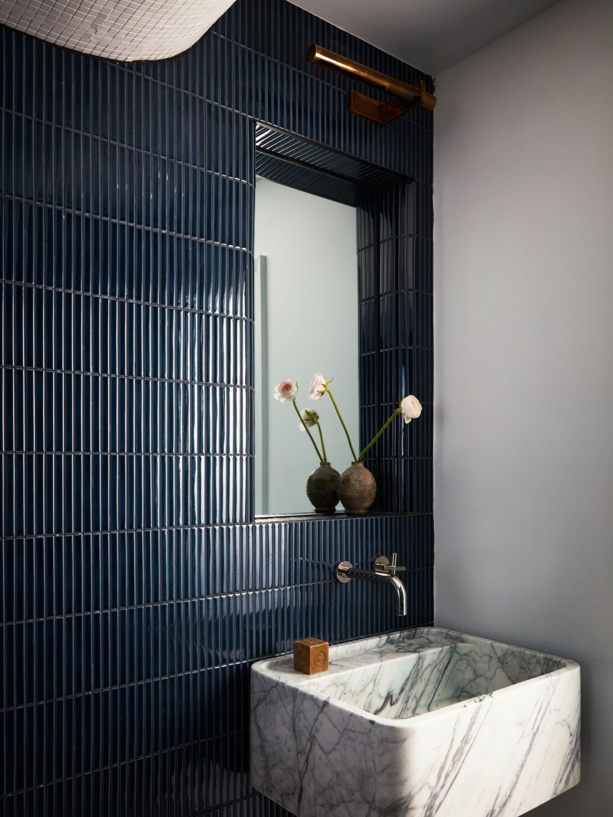 The basement full bath adheres to the overarching storm palette