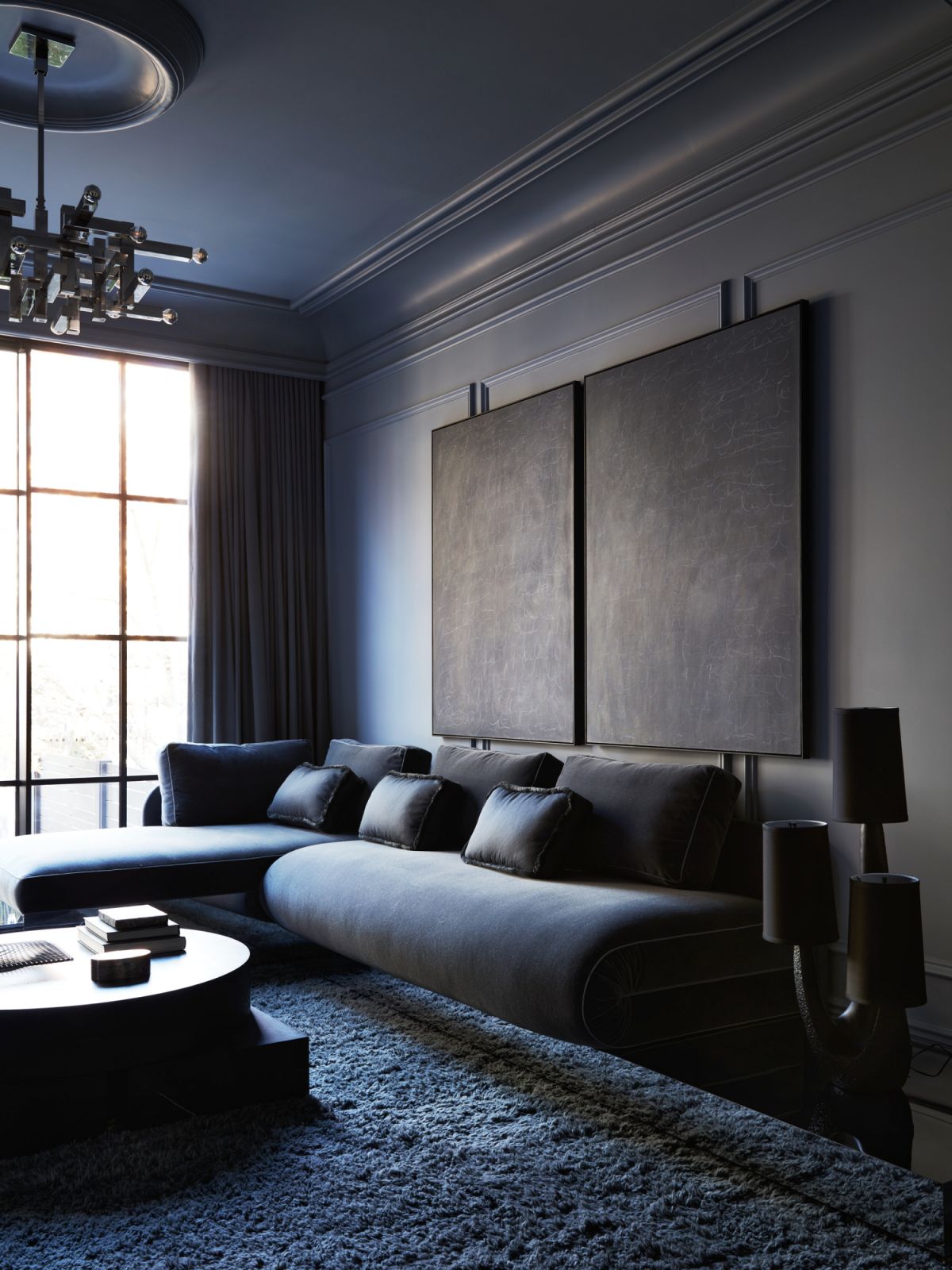 A custom-designed sofa ties well with the hard edges of ceiling light