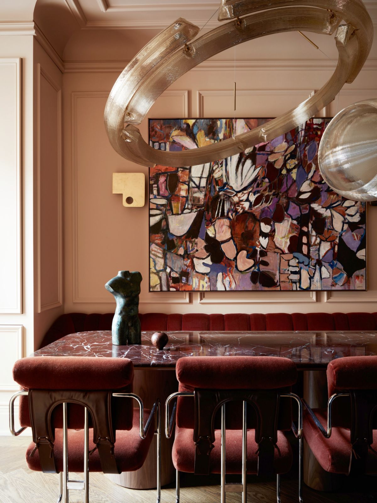 The pink dining room with a chandelier made from 3D printed plastics