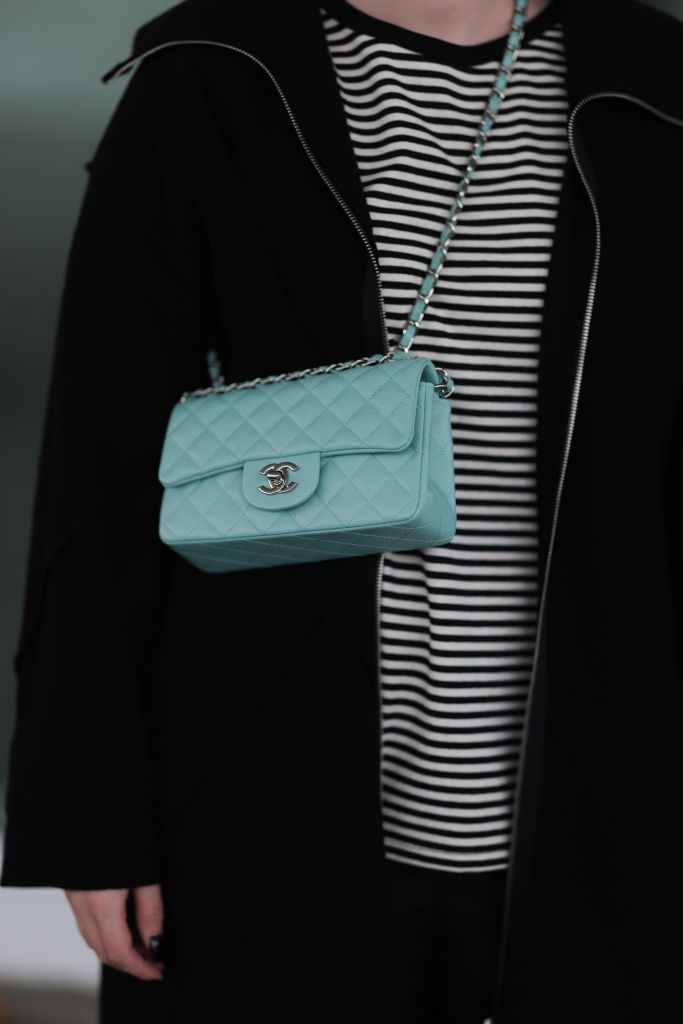 DUSSELDORF, GERMANY - NOVEMBER 05: Maria Barteczko seen wearing a black oversized wool coat by WENDYKEI, a black white striped shirt by WENDYKEI, a turquoise classic flap bag by Chanel on November 05, 2022 in Dusseldorf, Germany. (Photo by Jeremy Moeller/Getty Images)