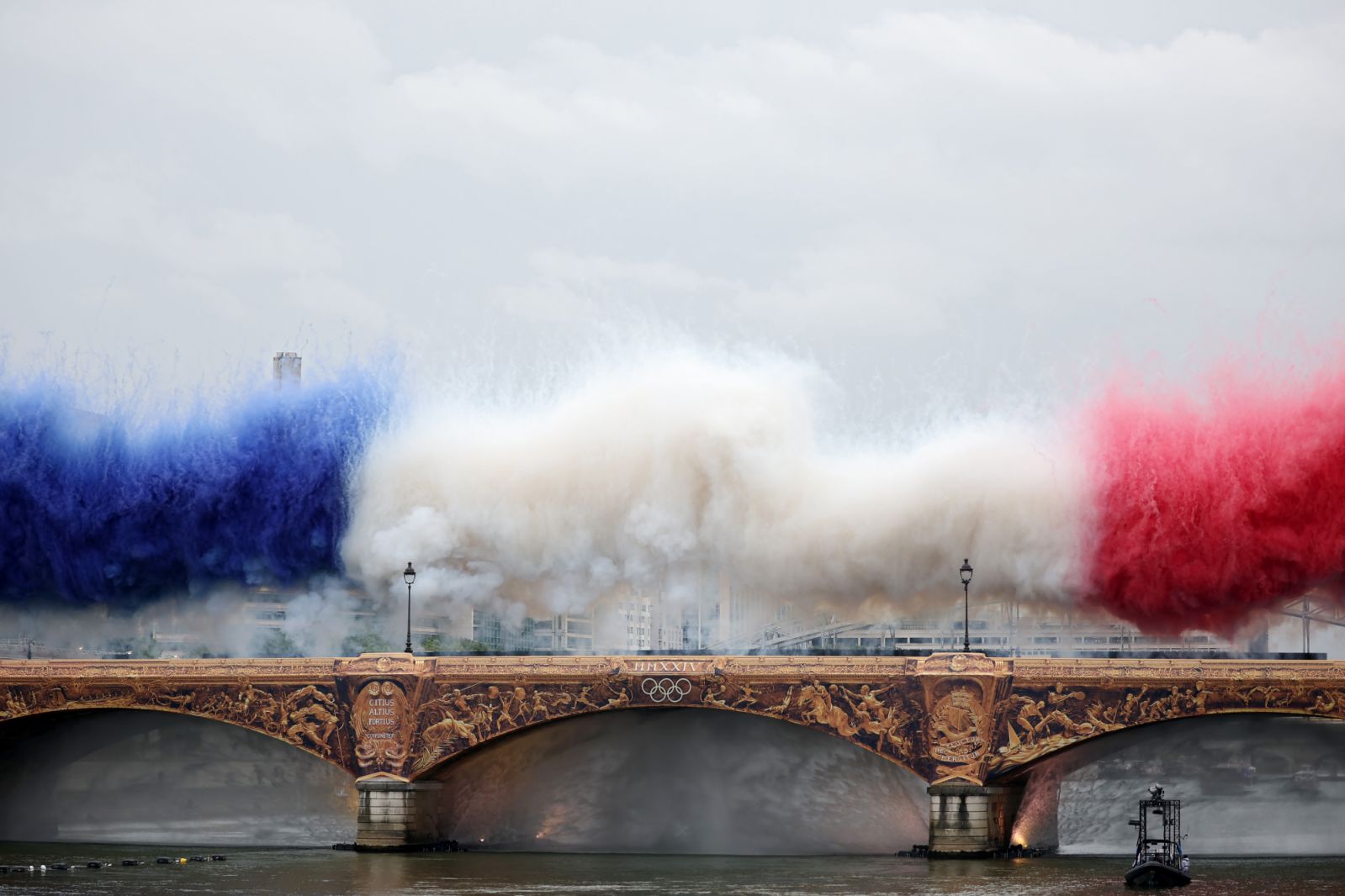 PARIS, FRANCE - JULY 26: Smoke resembling the flag of Team France is shown over Pont d’Austerlitz during the opening ceremony of the Olympic Games Paris 2024 on July 26, 2024 in Paris, France. (Photo by Jared C. Tilton/Getty Images)
