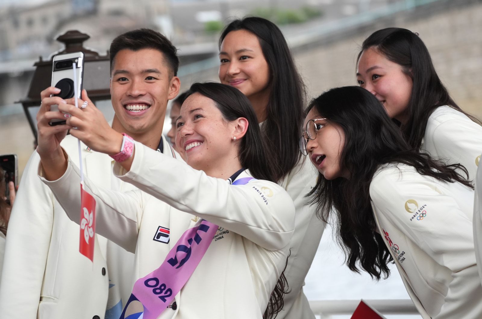 PARIS, FRANCE - JULY 26: Members of the delegation of Hong Kong, China pose for a selfie during the opening ceremony of the Paris 2024 Olympic Games on July 26, 2024 in Paris, France. (Photo by Lui Siu Wai - Pool/Getty Images)